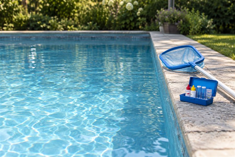 Pool service truck beside a backyard pool